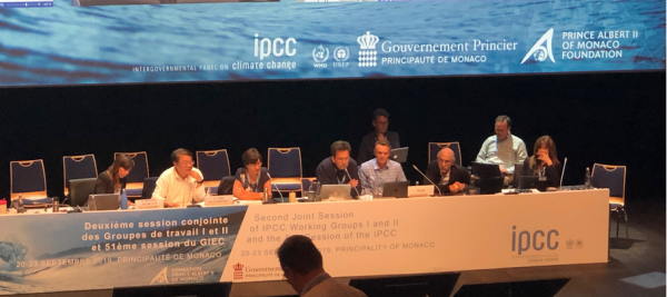 IPCC podium as authors discuss report approval